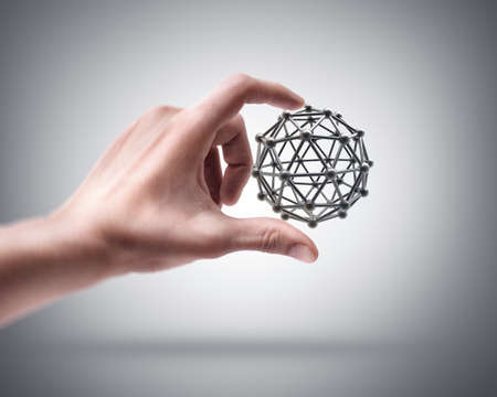 Man's hand holding molecules structure sphereの写真素材