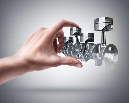 Man's hand holding Engine pistonsの写真素材