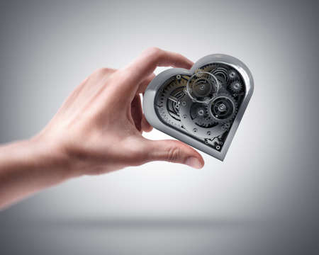Man's hand holding Mechanical heartの写真素材