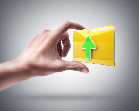 Man's hand holding Yellow folder with a symbolの写真素材