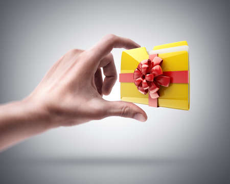 Man's hand holding Yellow folder with a symbolの写真素材