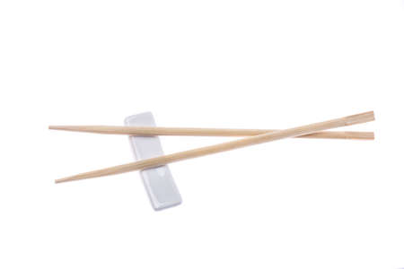 Wooden pairs of chopsticks on white background の写真素材