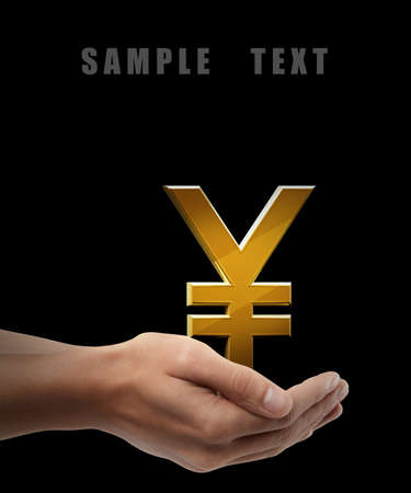 Golden yen simbol. Man hand holding object  isolated on black background. High resolution の写真素材