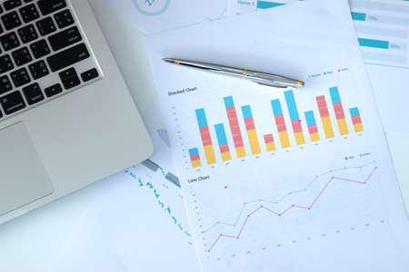 top view  office equipment on white table with graph document paper