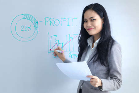 Asian business female  write graph and present analysis  resultの写真素材