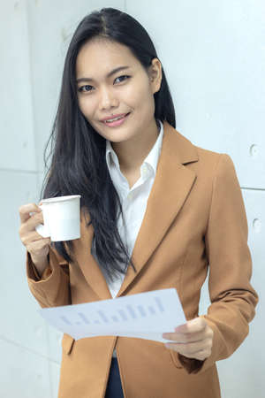 business woman work read document and drink a hot coffeeの写真素材