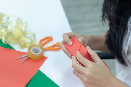 woman is wrapping up a present for Christmas or New Year