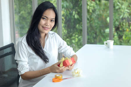 woman is wrapping up a present for Christmas or New Yearの写真素材