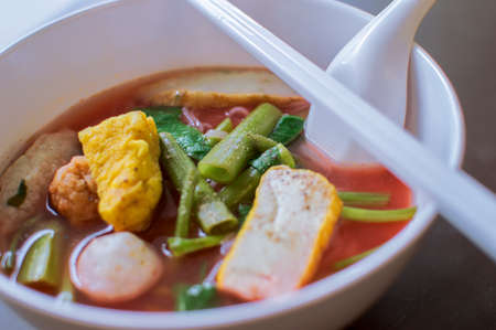Noodles with seafood soup and red sauceの写真素材