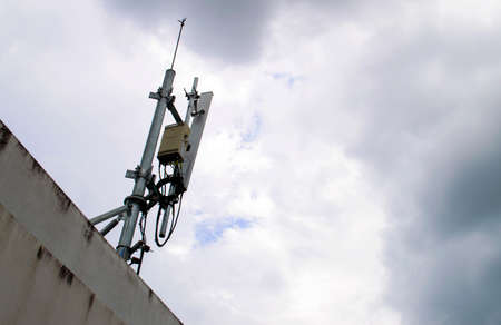mobile phone transmitter antenna on sky with many cloudsの写真素材