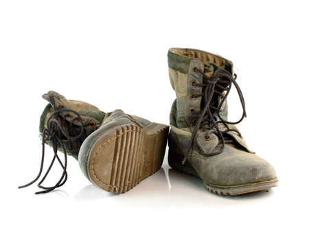 Old combat boots isolated on white background