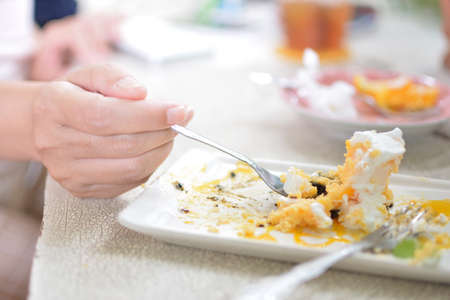 eaten delicious cake piece on plate on wooden tableの写真素材