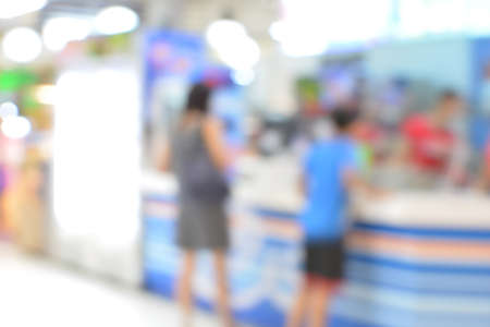 Blurred defocused grocery supermarket - Bright blur of people in shopping centerの写真素材