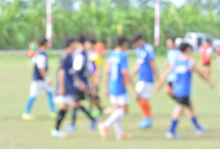 blur young children playing soccer on green soccer pitchの写真素材