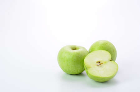 Ripe green apple and slice on white backgroundの写真素材