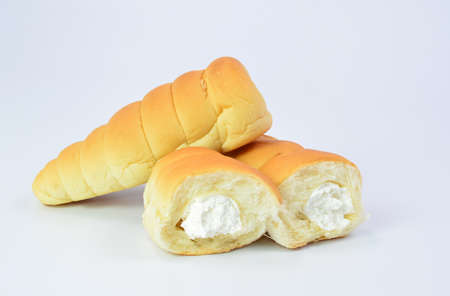 Bread with cream spiral on white backgroundの写真素材