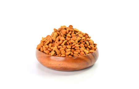 Dry dog food in bowl on white backgroundの写真素材