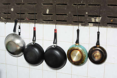 set of pans hanging in kitchenの写真素材