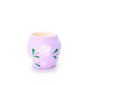 Colored jar painted with flowers on white backgroundの写真素材