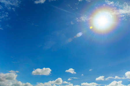 Blue sky with clouds and sun