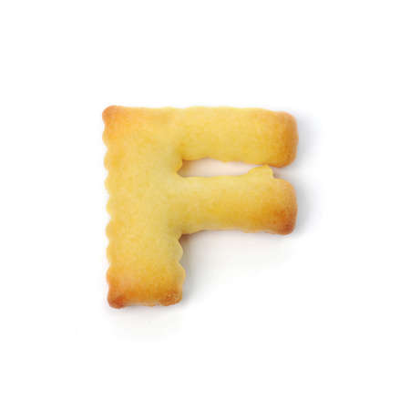 letter F made of cracker cookie isolated on white backgroundの写真素材