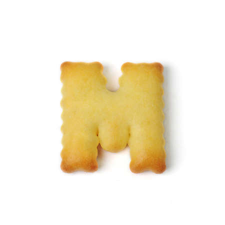 letter M made of cracker cookie isolated on white backgroundの写真素材