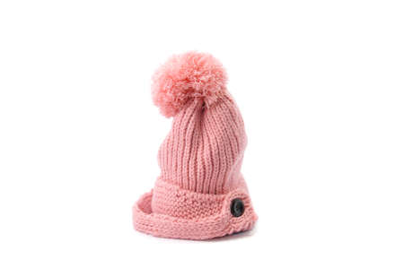 pink knitted hat with pompom isolated on white background