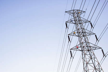 High-voltage tower with blue sky backgroundの写真素材