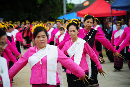 CHIANG-MAI, THAILAND - JULY 3: Thailand Festival for donating money to the temple for publishing Buddhism. The women dance to worship on July 03, 2017 at Chiang-mai province Thailand.のeditorial素材