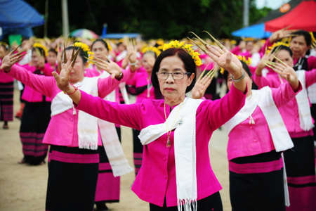 CHIANG-MAI, THAILAND - JULY 3: Thailand Festival for donating money to the temple for publishing Buddhism. The women dance to worship on July 03, 2017 at Chiang-mai province Thailand.のeditorial素材
