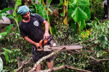 THAILAND-AUGUST,16 :Young man cutting wood to be used as firewood. THAILAND AUGUST,16 2017のeditorial素材