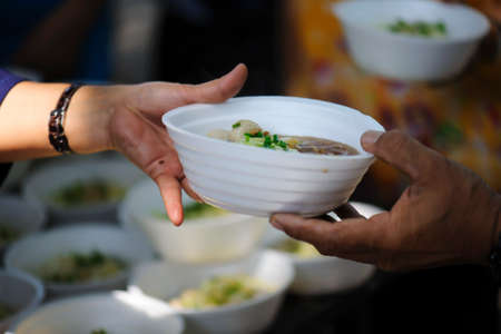 Feeding the poor to hands of a beggar. Poverty concept