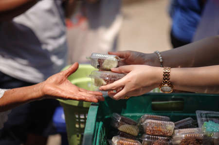 poverty concept feeding food for beggarの写真素材