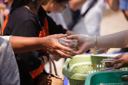 poverty concept feeding food for beggarの写真素材