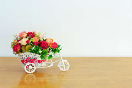 Artificial flower decoration on toy bike vaseの写真素材