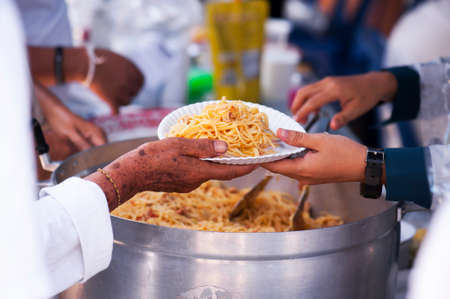 Feeding the poor to alleviate hunger. give conceptの写真素材