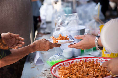 Feeding the poor to help each other in society. Charity conceptの写真素材