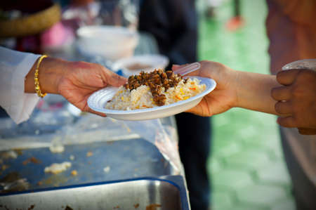 Rich people give food to the poor. starvation concept