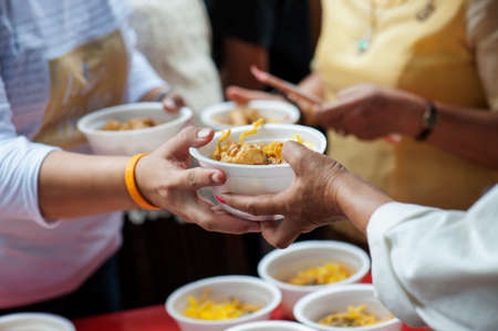 The hands of the poor donate food. Concept of famine