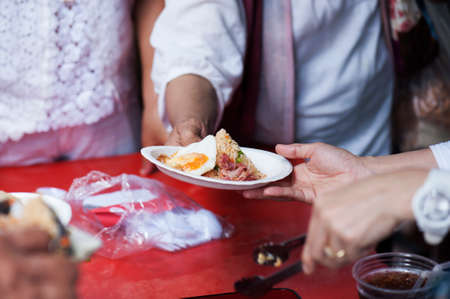 Helping the poor in society by donating food : The concept of hungerの写真素材