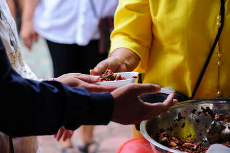 Helping the poor in society by donating food : The concept of hungerの写真素材