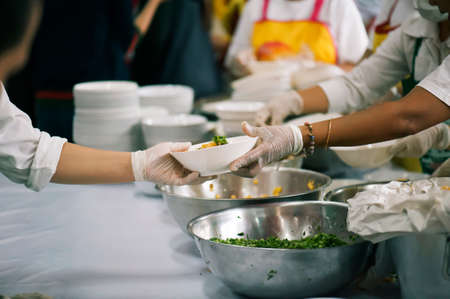 Volunteers Share Food to the Poor to Relieve Hunger: Charity conceptの写真素材
