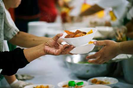 People who are rich and mentally assisting people in society, sharing food for the hungry : Help and Donation Conceptsの写真素材