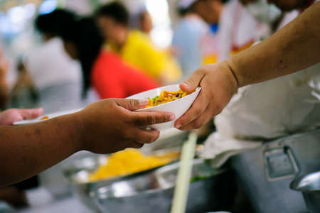 Volunteers Share Food to the Poor to Relieve Hunger: Charity concept