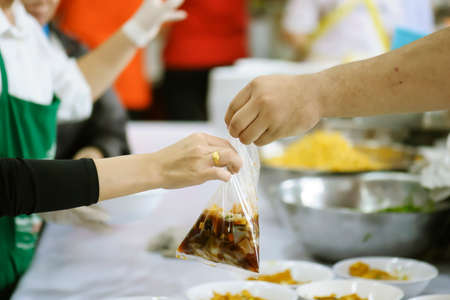 Volunteers Share Food to the Poor to Relieve Hunger: Charity conceptの写真素材