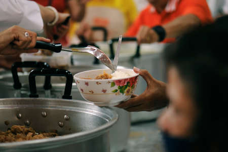 People who are rich and mentally assisting people in society, sharing food for the hungry : Help and Donation Conceptsの写真素材