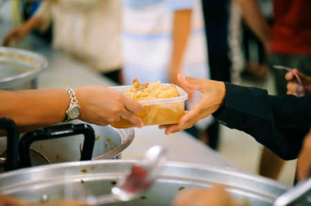People who are rich and mentally assisting people in society, sharing food for the hungry : Help and Donation Conceptsの写真素材