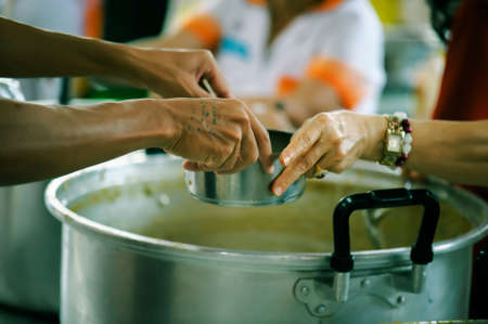 Feeding the hungry to get a taste for the poor Make humanitarian society : concept social contributionの写真素材