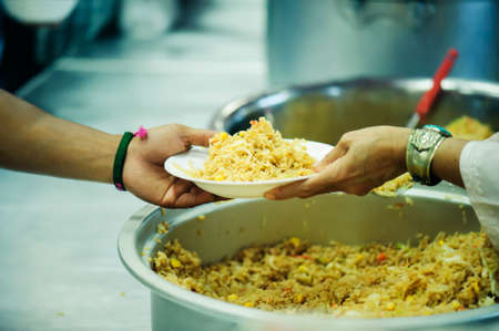 The hands of beggars offer food from the donor : The life of the poor