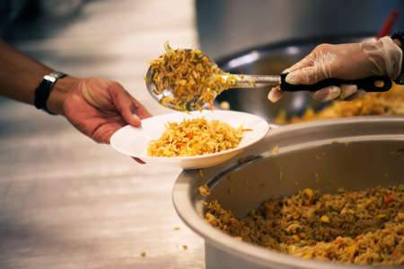 The hands of beggars offer food from the donor : The life of the poorの写真素材